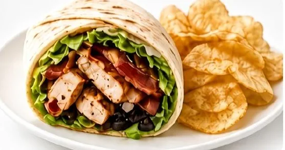 Chicken bacon wrap cut open, served with chips